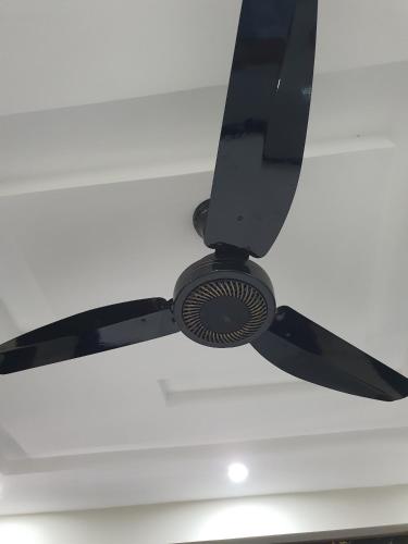 a ceiling fan is hanging from a white ceiling at Pova Hotel Suits and Apartments in Rawalpindi