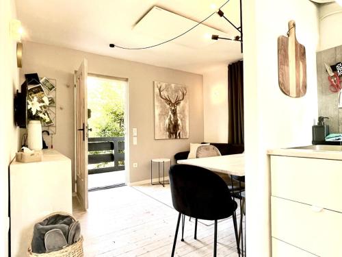 a kitchen and dining room with a table and chairs at Tiny Ferienhaus 4 am Rimbach in Steinau an der Strasse in Steinau an der Straße