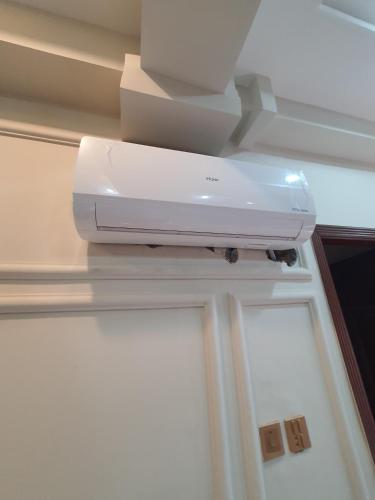 a printer sitting on a shelf in a room at Pova Hotel Suits and Apartments in Rawalpindi