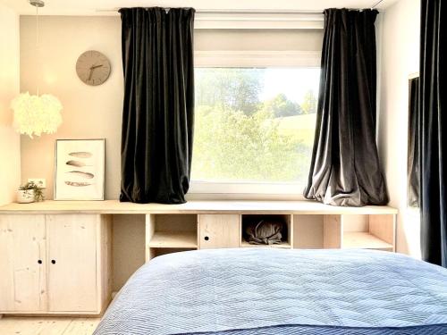 a bedroom with a bed and a window at Tiny Ferienhaus 4 am Rimbach in Steinau an der Strasse in Steinau an der Straße