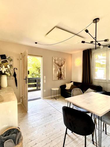 a living room with a table and a couch at Tiny Ferienhaus 4 am Rimbach in Steinau an der Strasse in Steinau an der Straße