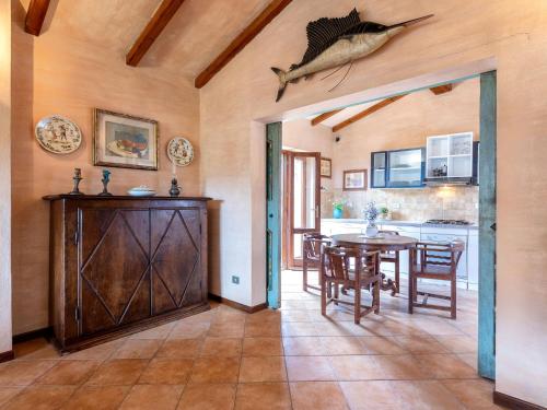 a kitchen and dining room with a table and a fish on the ceiling at Holiday Home Il Nido by Interhome in Li Valcaggi