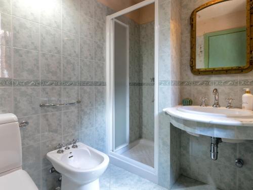 a bathroom with a sink and a toilet and a mirror at Holiday Home Il Nido by Interhome in Li Valcaggi