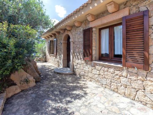 a stone house with a window on the side of it at Holiday Home Il Nido by Interhome in Li Valcaggi