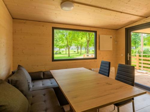 a dining room with a wooden table and chairs at Holiday Home Wood Cube by Interhome in Sachsenburg