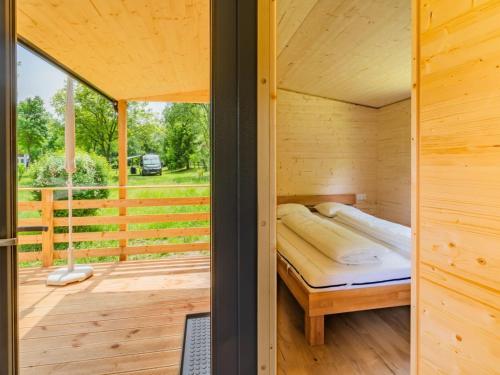 a room with a bed in a wooden house at Holiday Home Wood Cube by Interhome in Sachsenburg