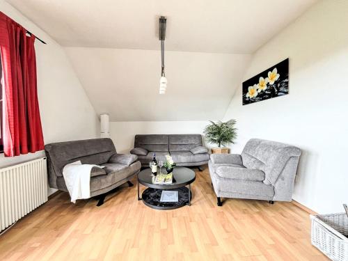 a living room with two couches and a table at Apartment Grandpa by Interhome in Frankenau