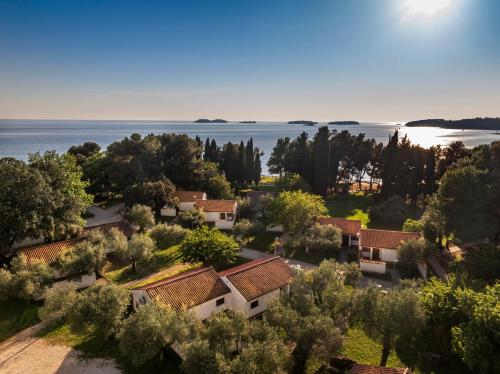 an aerial view of a village with trees and water at Maistra Select Villas Rubin Resort in Rovinj