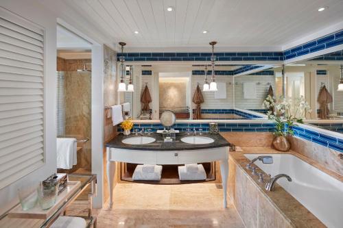 a bathroom with two sinks and a tub at Mandarin Oriental, Bangkok in Bangkok