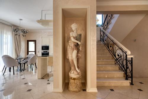 a statue of a woman on a column in a living room at Argaka Luxury Residence in Paphos City