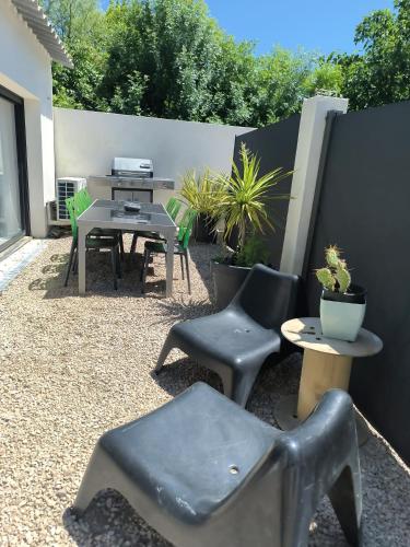 a patio with chairs and tables and a table and chairs at Villa MOOJŸ in Carcès