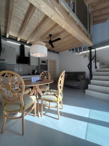 a kitchen and dining room with a table and chairs at La LIPA SUITES con piscina privada in Almáchar