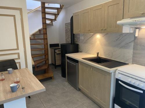 a kitchen with a sink and a stove top oven at Holiday Home Le Rouge gorge by Interhome in Saint-Lo-dʼOurville