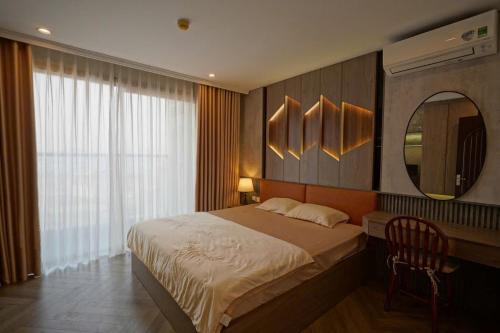 a bedroom with a large bed and a mirror at Happy Home in Ha Long