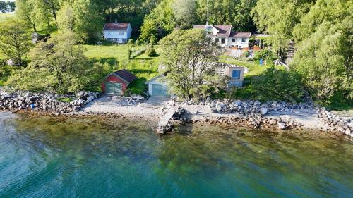 an aerial view of a house next to a body of water at Beautiful Beach line Cabin with sauna near Pulpit Rock in Forsand