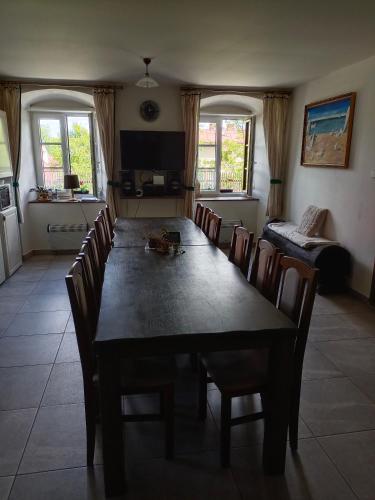 a dining room with a long table and chairs at Chalupa u Jirky in Staré Ransko