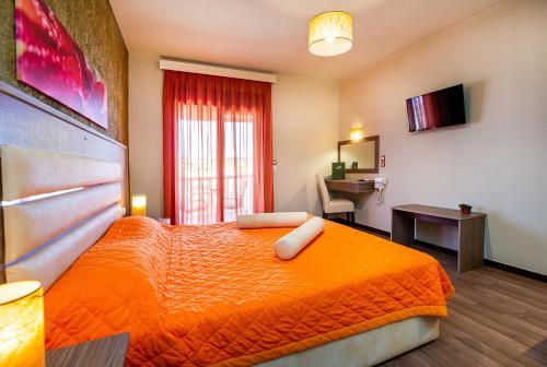 a bedroom with an orange bed in a room at Garden in Limenaria