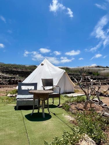 a tent with a table and a bench in front of it at Adeje - TwinFin Hostel & Surf Yoga Camp in Callao Salvaje