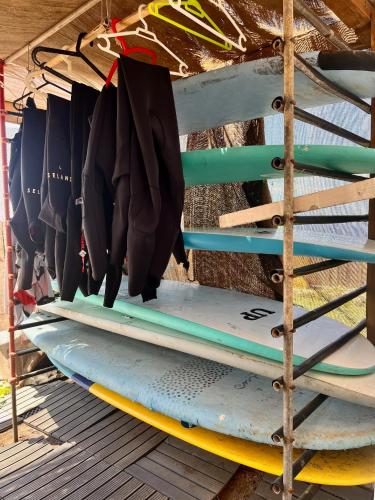 a stack of surfboards sitting on a rack at Adeje - TwinFin Hostel & Surf Yoga Camp in Callao Salvaje