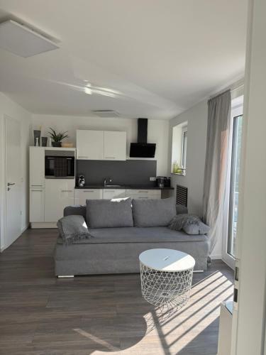 a living room with a couch and a table at Thirty for Three in Kürten