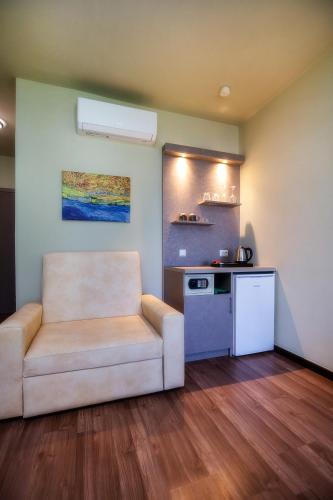 a living room with a couch and a kitchen at Garden in Limenaria