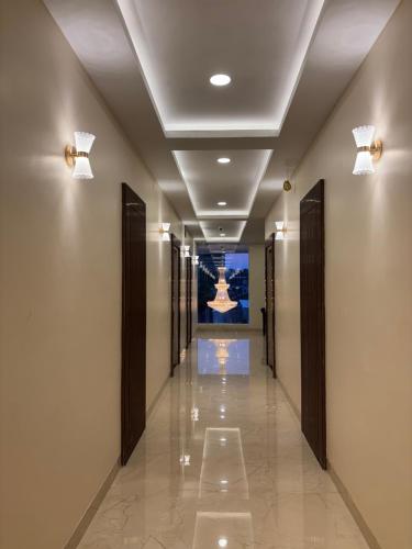 a hallway of a building with a painting on the wall at Hotel Saesha International in Rāmeswaram