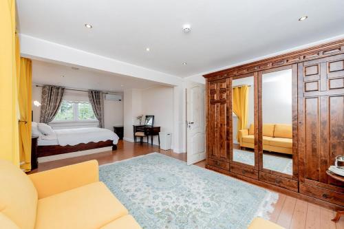 a living room with a couch and a bed at Luxury Villa in Pärnu, walking distance from the beach and city centre in Pärnu