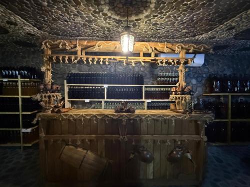 a bar with a lot of bottles of wine at Guest House KHONI in Khoni