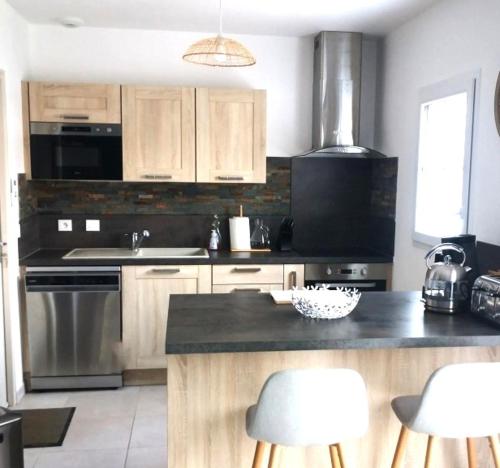 a kitchen with a sink and a stove top oven at Villa Ibisa in Angles