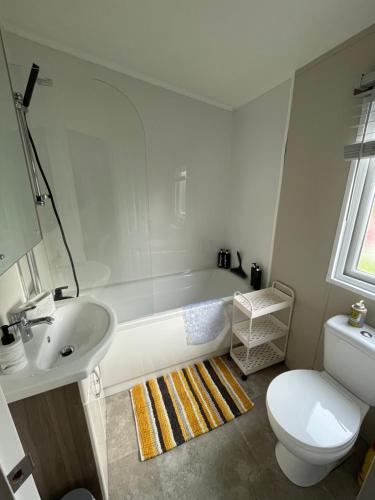 a bathroom with a tub and a toilet and a sink at Bowland Fell Retreat in Tosside