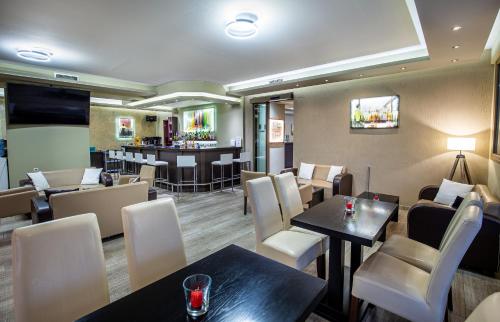 a restaurant with tables and chairs and a bar at Garden in Limenaria