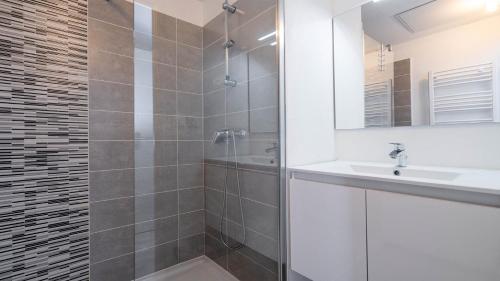 une salle de bain avec un lavabo et une douche dans l'établissement La Dune N 51 - VILLA 2P4, à Sérignan