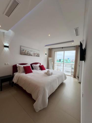 a bedroom with a large bed and a large window at Luxe and Spacious HassanTower View Downtown stay in Rabat