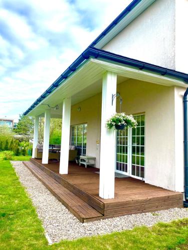 a porch with a wooden deck on a house at Luxury Villa in Pärnu, walking distance from the beach and city centre in Pärnu