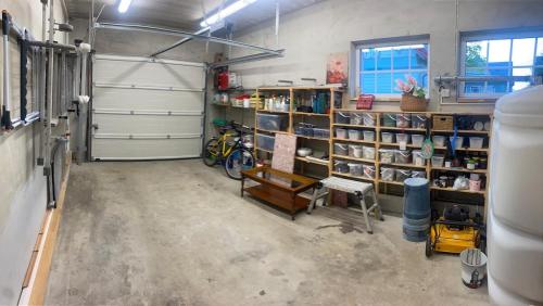 a garage with shelves of books in a room at Luxury Villa in Pärnu, walking distance from the beach and city centre in Pärnu