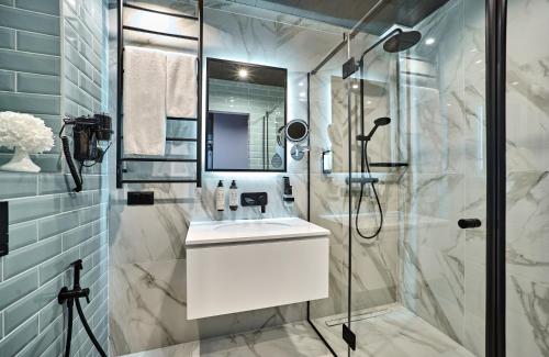 a bathroom with a sink and a shower at CITYHOTEL Residence in Kyiv