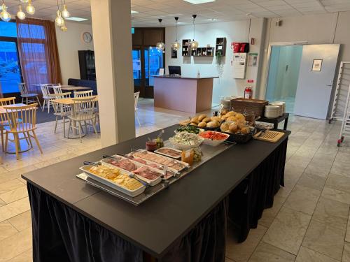 a table with a buffet of food on it at Hotell Fyrislund in Uppsala