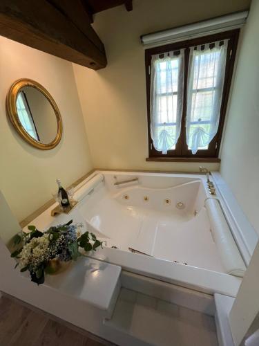 a white bath tub in a bathroom with a window at Casale Antica Cassia Beauty Spa in Rome