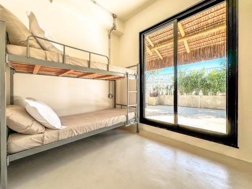 a bedroom with bunk beds and a large window at Rio Bem-te-vi in Rio de Janeiro