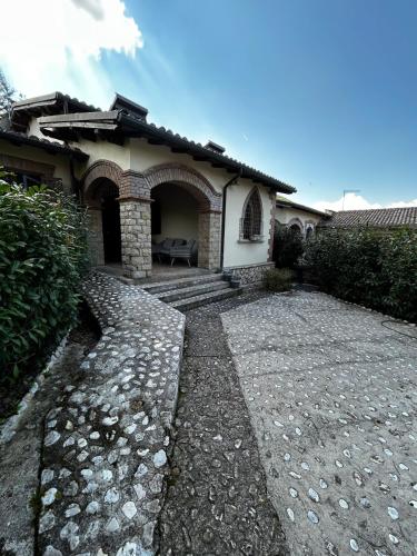 a house with a stone walkway in front of it at Chalet Il Ballatoio in Rocca di Botte