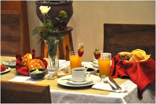 a table with breakfast foods and orange juice on it at Mont Gueliz in Marrakech