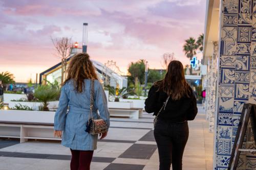 two women are walking down a sidewalk at Historic center apartment Cascais in Cascais