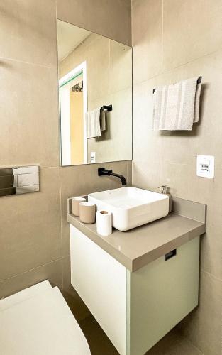 a bathroom with a white sink and a mirror at Rio Bem-te-vi in Rio de Janeiro