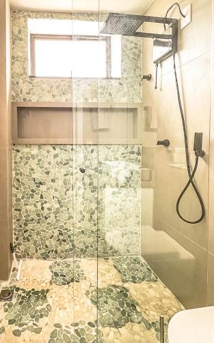 a bathroom with a shower with a glass door at Rio Bem-te-vi in Rio de Janeiro