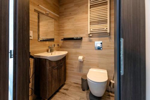 a small bathroom with a sink and a toilet at Restaurace Hotel Praha in Nižbor