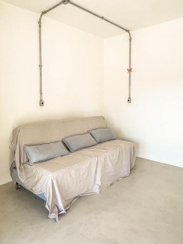 a bed in a white room with two pillows on it at Rio Bem-te-vi in Rio de Janeiro