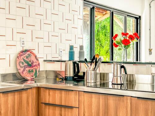 a kitchen counter with a sink and a window at Rio Bem-te-vi in Rio de Janeiro