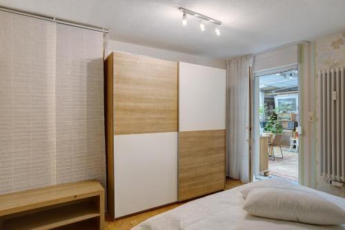 a bedroom with a bed and a large closet at Ferienwohnung Ihmert in Hemer