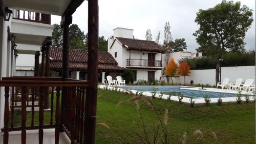 a house with a swimming pool in a yard at Posada de los Poetas Hotel Boutique in San Lorenzo