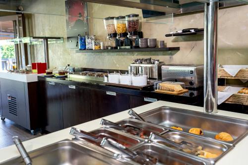 a kitchen with a sink and a counter with food at Garden in Limenaria